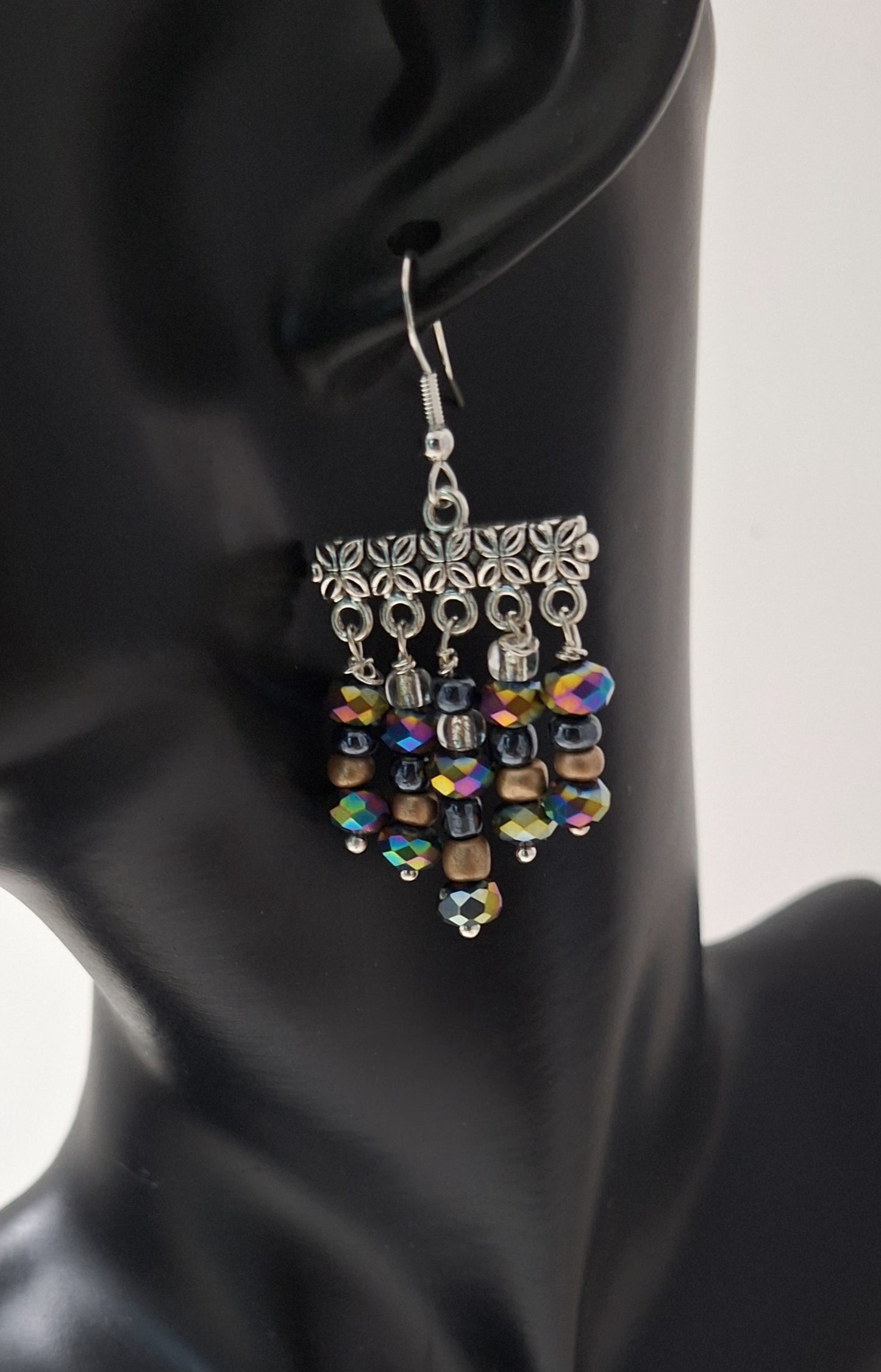 Measurements: 1 1/4" (not including the Sterling silver ear wire).
Six colorful beads in graduating sizes - including iridescent Rondelle beads, gold, black Hermatite, and clear beads. 