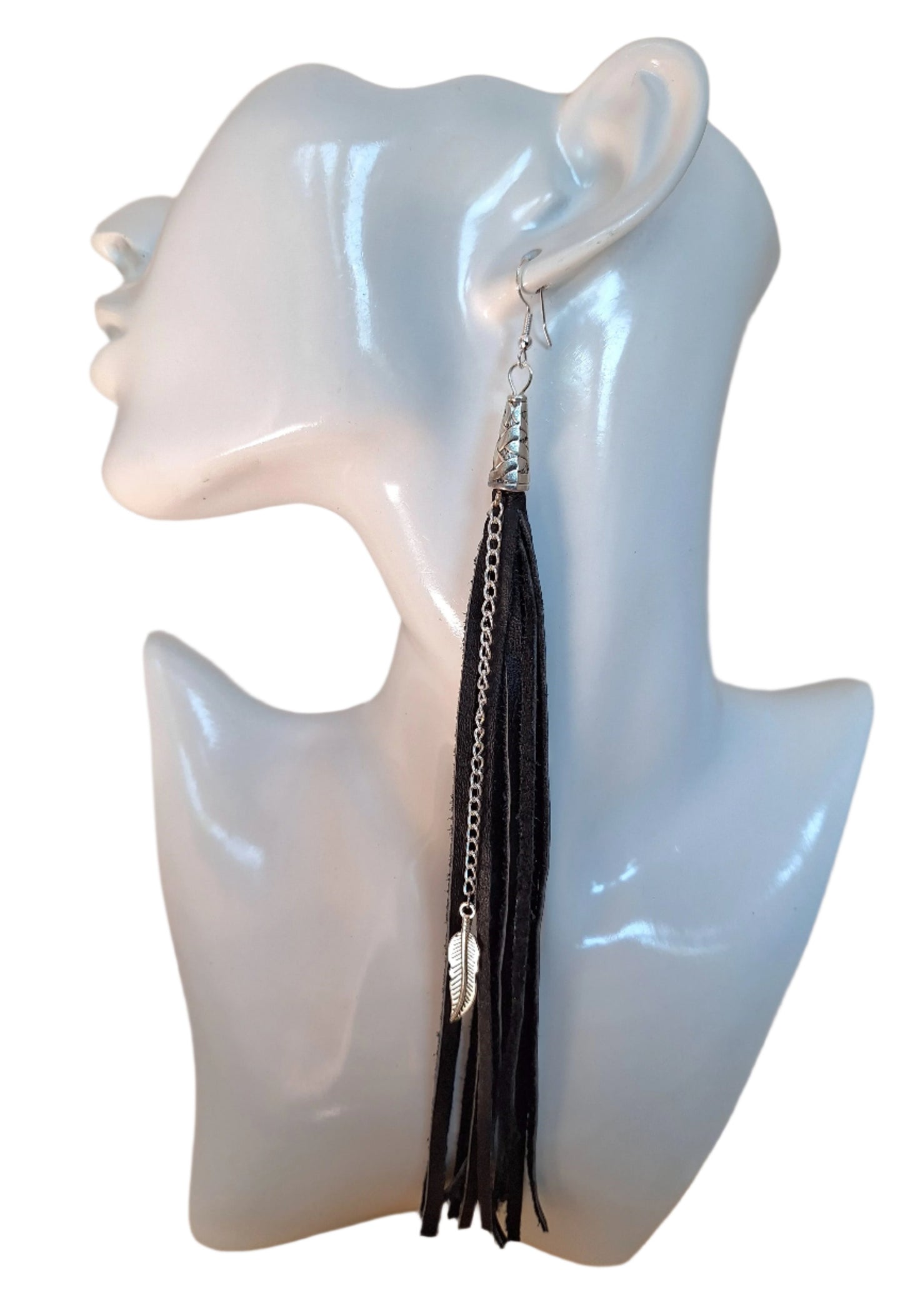 These are a style spin on our Black Leather Tassel earrings (1/4").
The Spaghetti Tassel is 1/8" wide, the same genuine leather however, they are paired with a stainless steel chain and a 1" metal leaf.
Measurements: 7 1/2" long not including the Sterling silver ear wire.