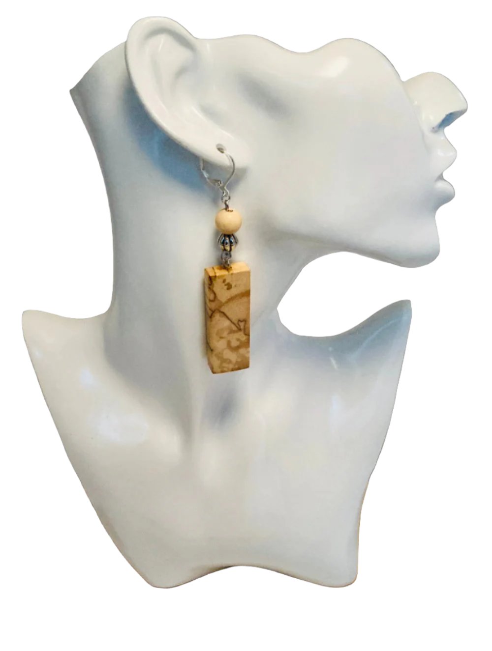 Spalted Birchwood naturally creates an image that is embedded into the wood. It is as authentic as it is beautiful. A couple coats of polyurethane put on to protect its beautiful finish. Two small beads (1 wood & 1 alloy) were added for a more modern look. Finished with a claw snap-type hypoallergenic ear hook. Measurement: 1 1/4 x 3 1/4These are a limited edition item. No two pair will be exactly the same. 