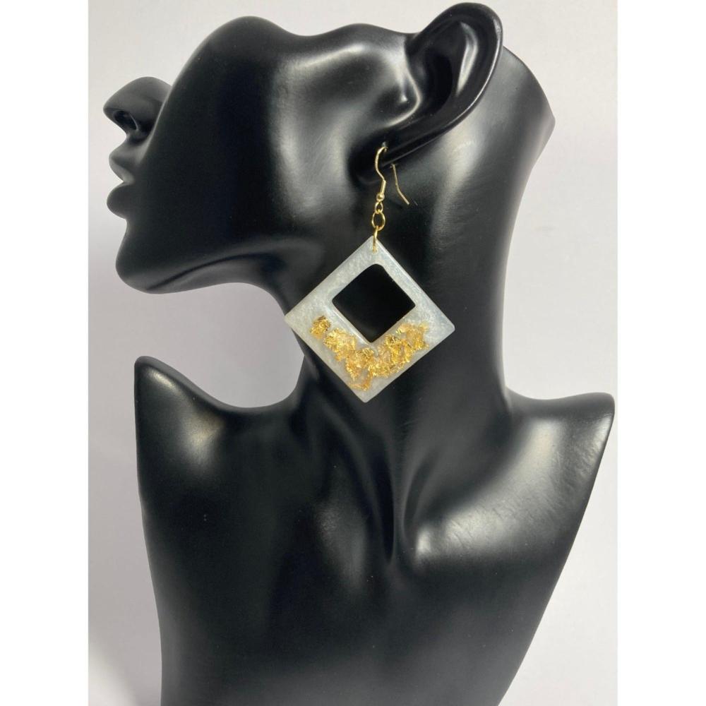 Shown here is the Gold Frost option. A diamond shaped earring made by embedding gold flakes into a white marbleized resin. This earring really sparkles. Also available in a Smoky Copper option. Approx. 2 3/4" in size not - including the hypoallergenic gold color ear wires.
