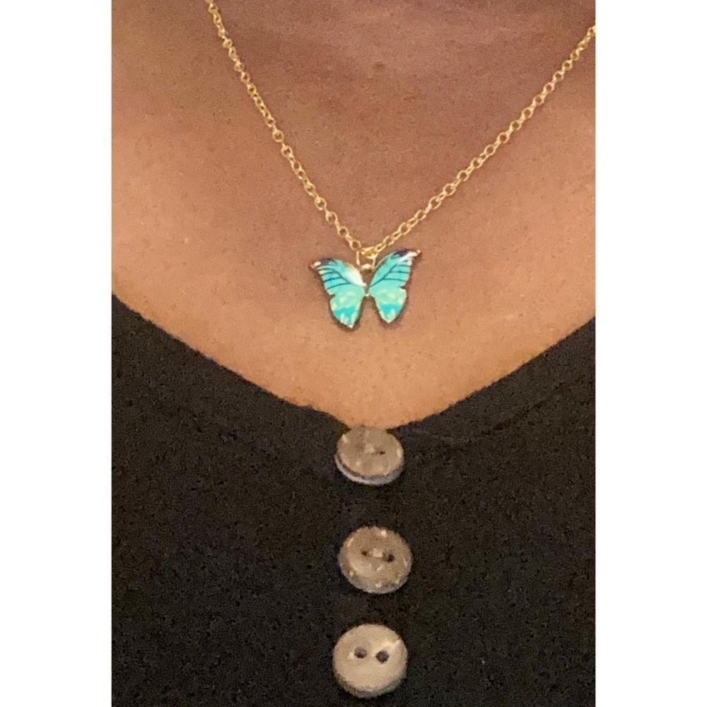 This painted butterfly charm is Light Teal and Black. It is paired with a high quality gold plated chain that really sparkles and will keep its shine for an extended period of time.