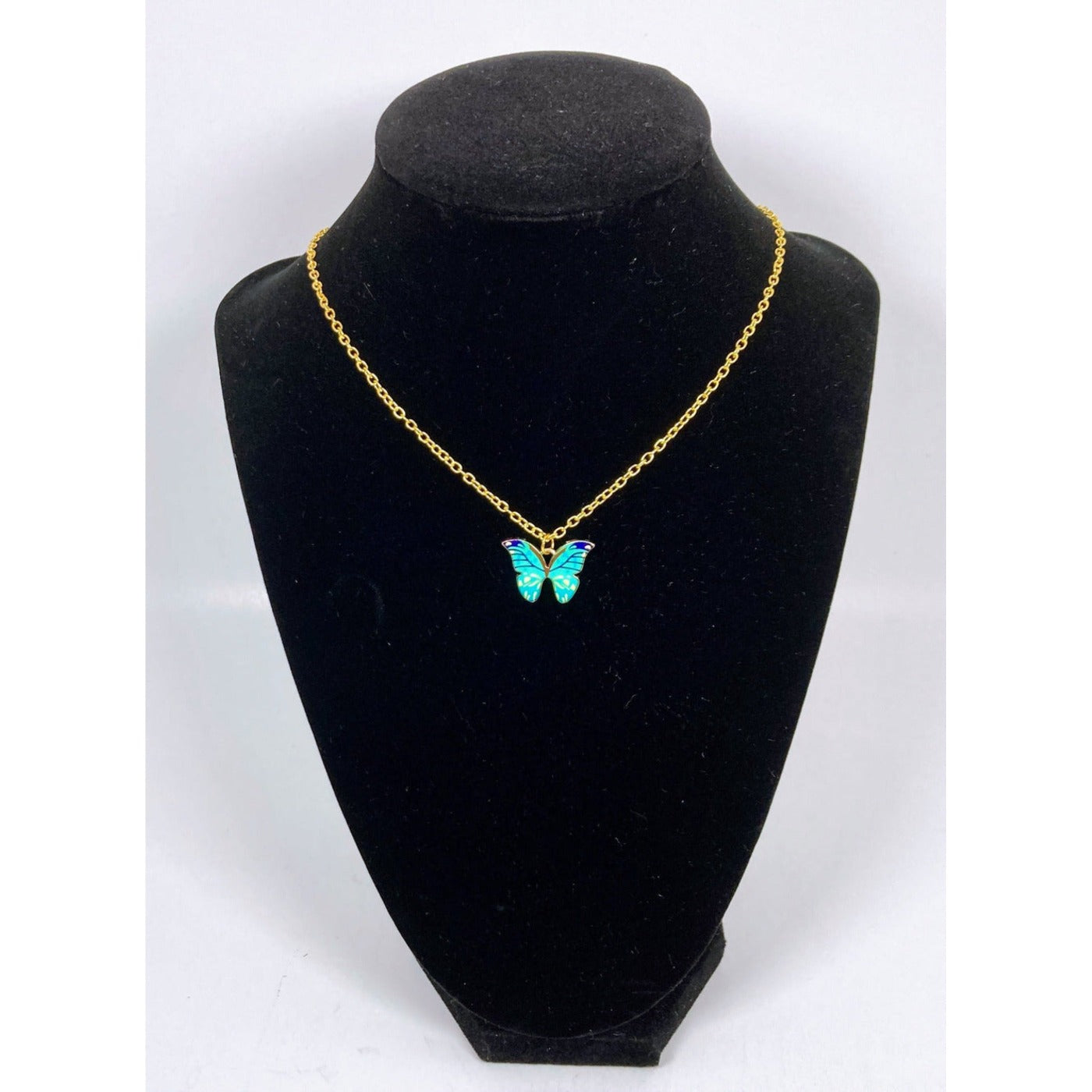 View #2 of this painted butterfly charm is Light Teal and Black. It is paired with a high quality gold plated chain that really sparkles and will keep its shine for an extended period of time.
