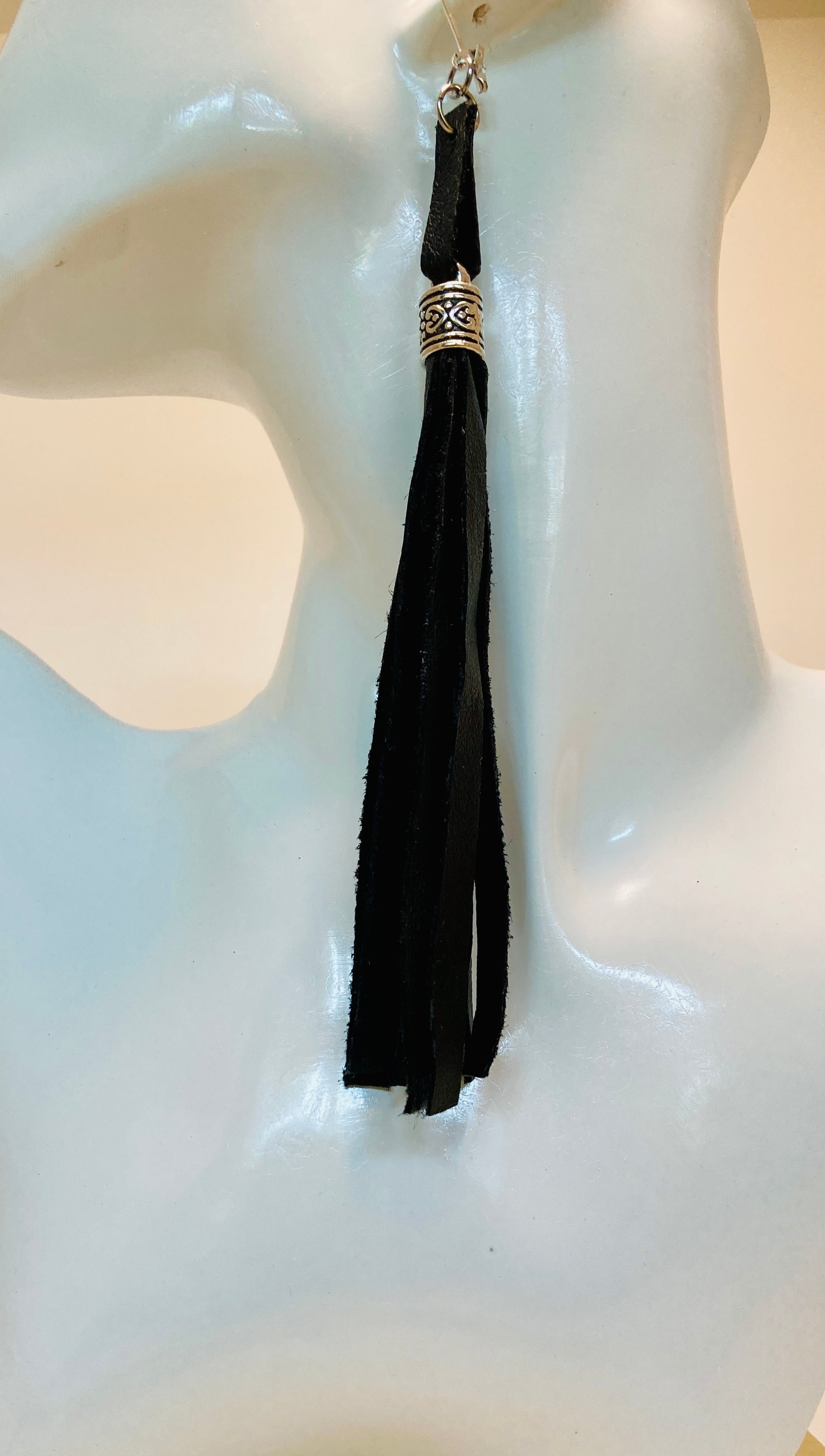 Black Leather Tassel earrings. These fashionable accessories exude elegance and sophistication, allowing you to make a lasting impression.

Complete your ensemble with the exclusive matching choker chain (sold separately) for the ultimate touch of style.
Measuring at 5 3/4" in length (excluding the hypoallergenic Stainless Steel lobster ear wire), these earrings are the perfect addition to your wardrobe.