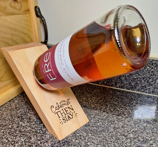 This compact wooden board (9x5") seems to defy gravity.
Available in Golden Pecan (GP) stain finish.
Currently avail. in  3 quirky phrases burned into each board: 1 - Cabernet Then Slay, 