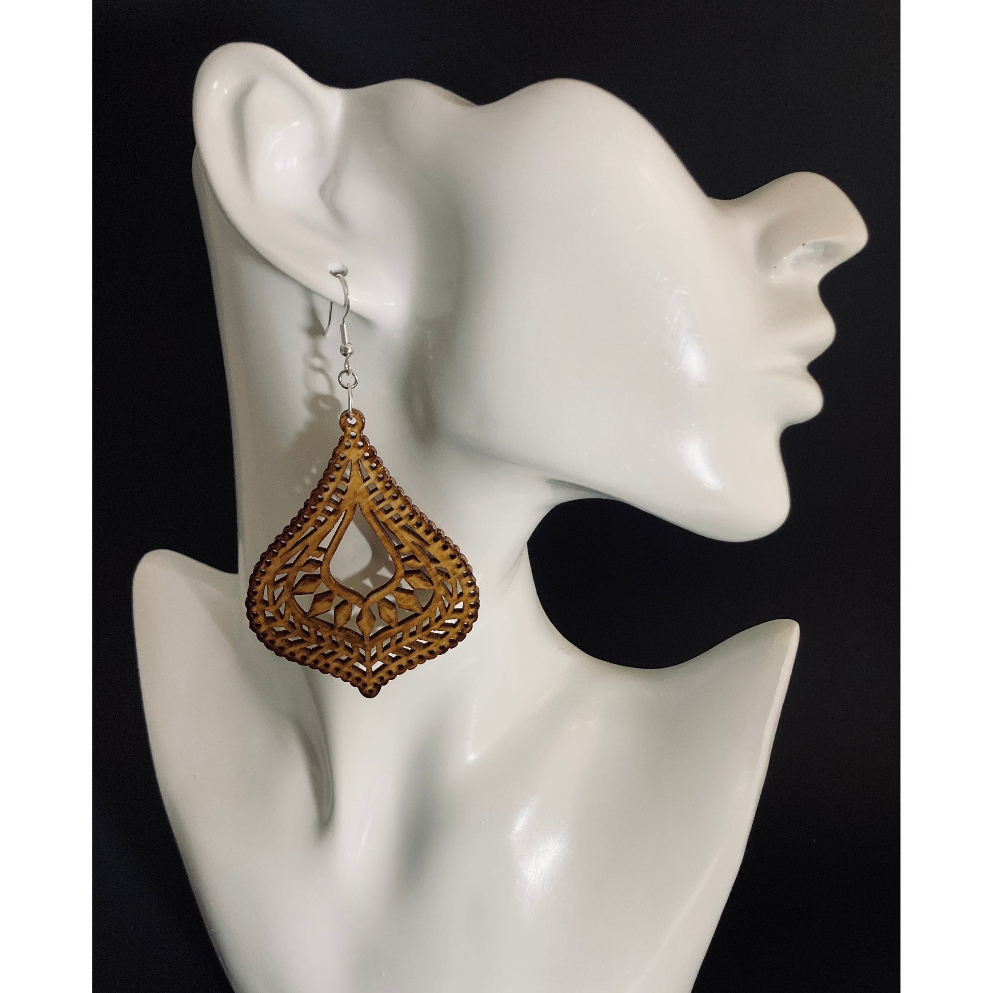 Wooden Dangle Earrings - Design 1 of 12. This earring has an Asian inspired design. (measures approx. 3x2.5" at it's widest points)It is bell shaped with a pointed end at bottom. The many intricate cutouts gives this design real appeal. Finished with Sterling silver ear wires. 