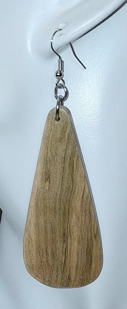 A single teardrop-shaped wooden dangle earring with a natural wood grain finish and a silver-tone fishhook ear wire, shown hanging against a plain white background.