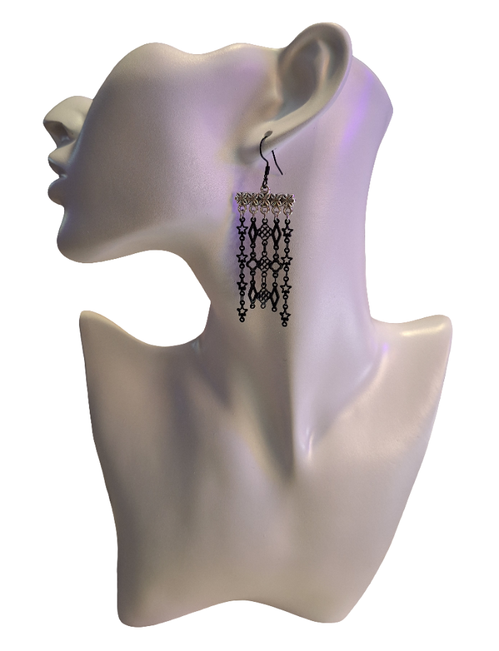 Three different black chain designs hang from a five bar attachment in silver. Paired with a black enameled Hypoallergenic ear wire.
