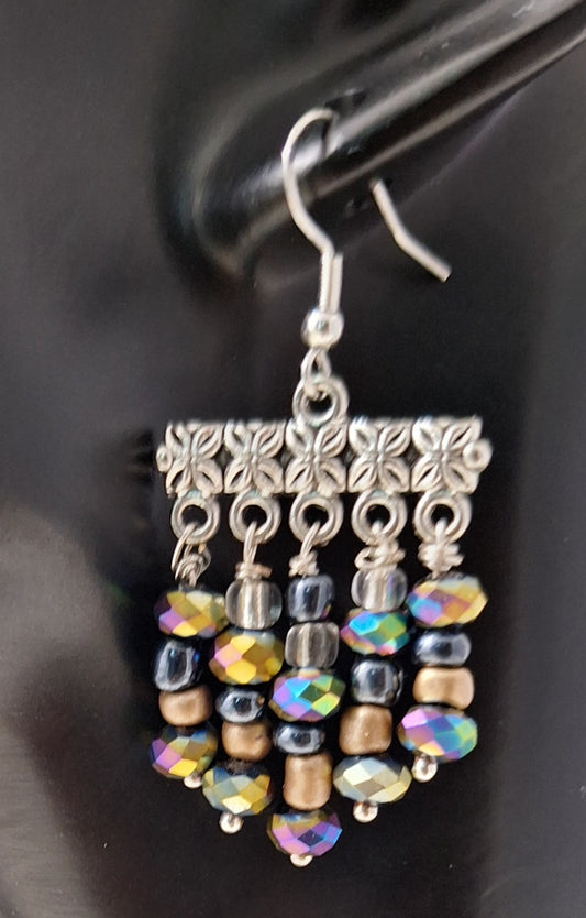 Make a statement with this playful and stylish Festive pair. You'll be the life of the party and well accessorized for any occasion.

Measurements: 1 1/4" (not including the Sterling silver ear wire).&nbsp;
Six colorful beads in graduating sizes - including iridescent Rondelle beads, gold, black Hermatite, and clear beads.&nbsp;