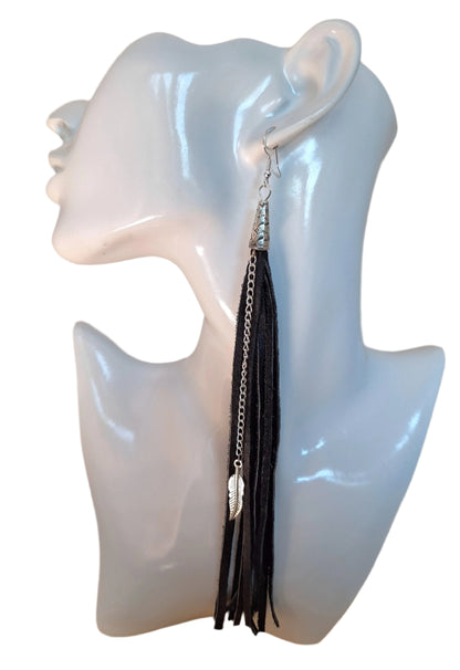 These are a style spin on our Black Leather Tassel earrings (1/4").

The Spaghetti Tassel is&nbsp;1/8" wide, the same genuine leather however, they are paired with a stainless steel chain and a 1" metal leaf.&nbsp;
Measurements: 7 1/2" long not including the Sterling silver ear wire.