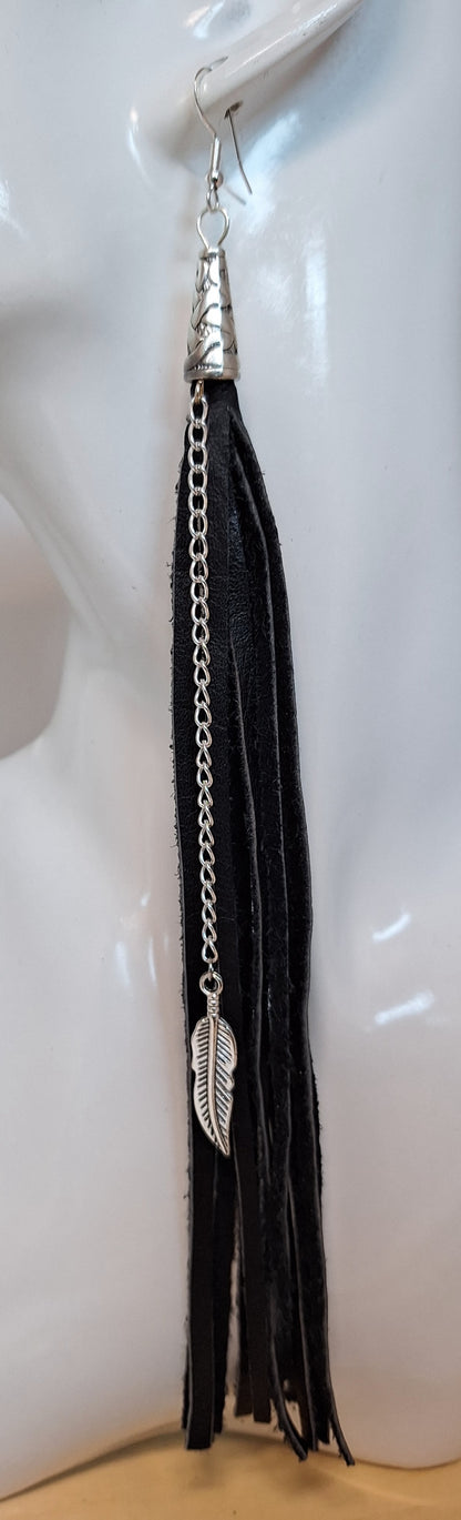 These are a style spin on our Black Leather Tassel earrings (1/4").

The Spaghetti Tassel is&nbsp;1/8" wide, the same genuine leather however, they are paired with a stainless steel chain and a 1" metal leaf.&nbsp;
Measurements: 7 1/2" long not including the Sterling silver ear wire.