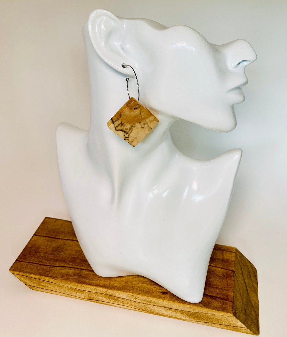 These authentic wooden earrings are made from Spalted Birch Exotic Wood. The wood is cut and book-matched more precise image. Nature dictates that no two pair of this design is exactly&nbsp;alike. Measuring 1" square (approx.) and paired with a 1 1/4" stainless steel hypoallergenic hoop.&nbsp;