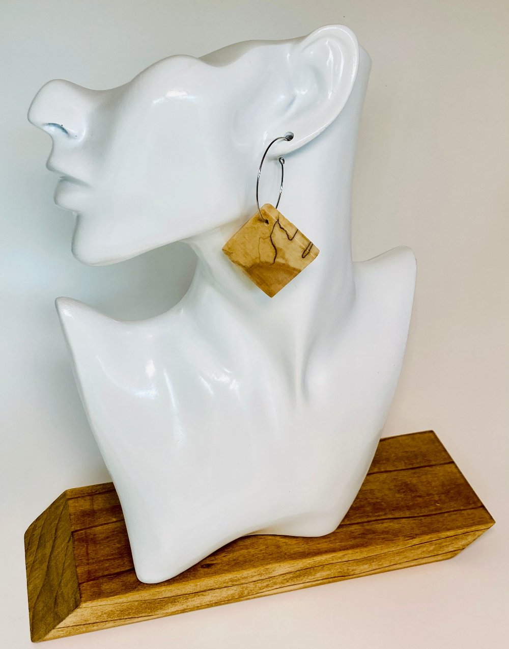 These authentic wooden earrings are made from Spalted Birch Exotic Wood. The wood is cut and book-matched more precise image. Nature dictates that no two pair of this design is exactly&nbsp;alike. Measuring 1" square (approx.) and paired with a 1 1/4" stainless steel hypoallergenic hoop.&nbsp;