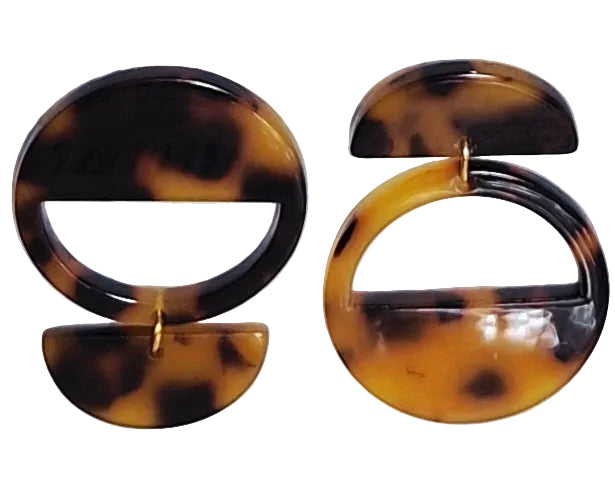 Tortoise shell hoop earrings on a light background.
