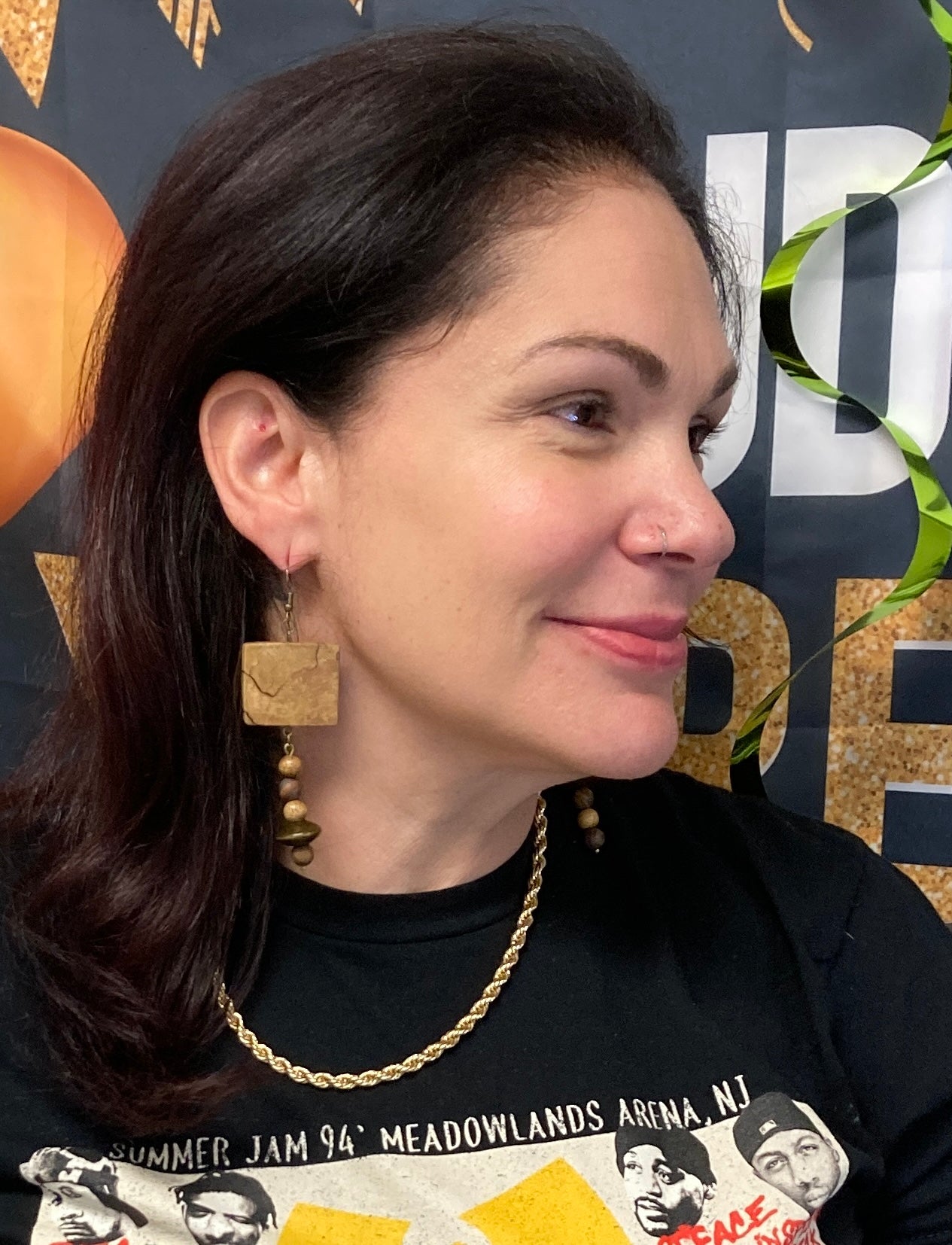 Woman wearing rustic earrings and a necklace with a blurred background