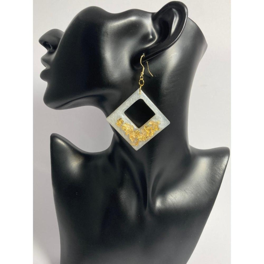 Shown here is the Gold Frost option. A diamond shaped earring made by embedding gold flakes into a white marbleized resin. This earring really sparkles. Also available in a Smoky Copper option.  Approx. 2 3/4" in size not - including the hypoallergenic gold color ear wires. 