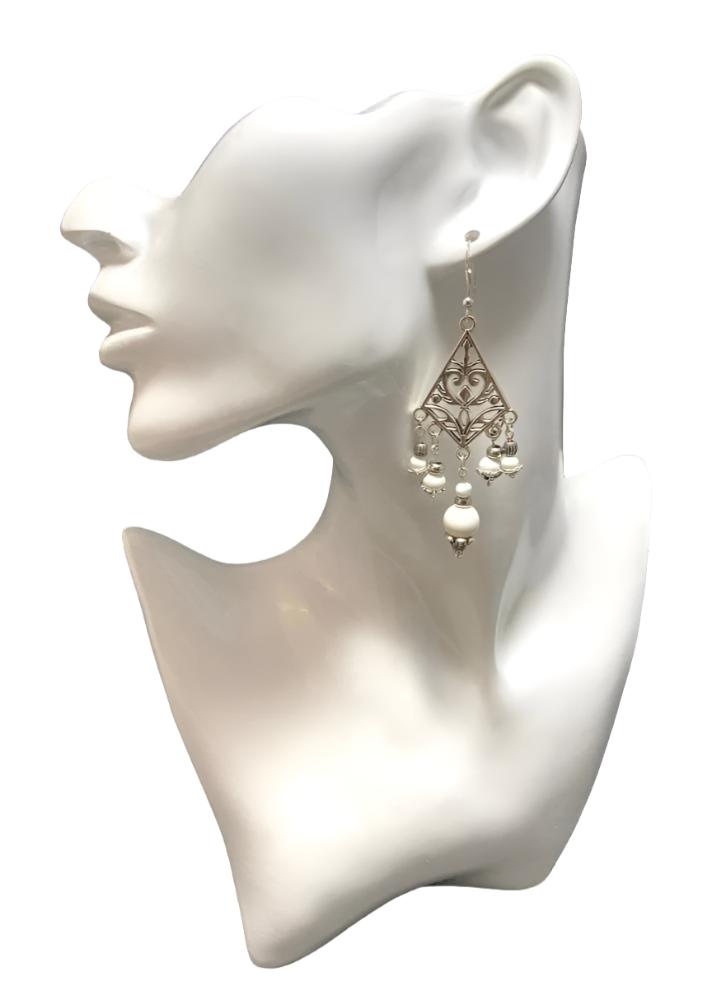 The Chandelier Vintage look Earrings: This pair has solid white beads with coordinating silver spacer beads. They are Antique Tibetan Silver with 5 rows of solid white beads hanging from three levels. Approximately 3.5" long & finished with a Sterling silver ear wire.