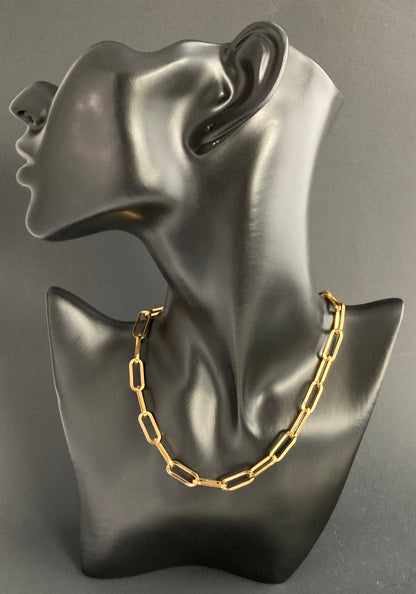 (Shown) Chunky Paper Clip Chain. Gold plated stainless steel. Our Paper Clip Chains now come in three distinguished finishes-Black, Silver Plated, and Gold Plated-each offering a unique shape: Black is rounded while the Plated variants are square. Lengths of 16" (Choker), 18", and 22". All are available in both choker and necklace styles, with an especially-sized hoop for added ease when connecting the clasp. With an occasional wipe, your chain will stay sparkling and bright.