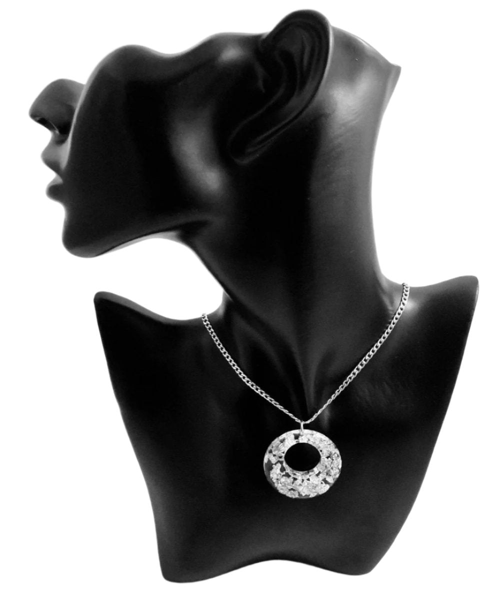 Our stunning Silver Bursts Charm Necklace will make a beautiful addition to any outfit! This elegant necklace features a radiant silver/translucent charm suspended from an eye-catching, sparkling chain, available in lengths of 20" and 22". Add a touch of sophistication to any wardrobe with this exquisite piece.