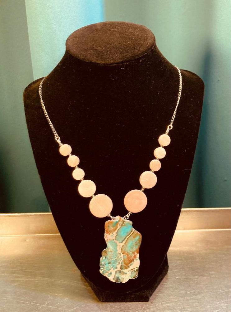 A Turquoise and natural wood necklace. Made with exquisite craftsmanship, its turquoise look is finished with a comfortable stainless-steel chain and a reliable clasp for added convenience. Make your look stand out with this timeless piece. Note: Stones will vary slightly by size and colors design but will include Turquoise, Brown, Reddish Brown & Cream.