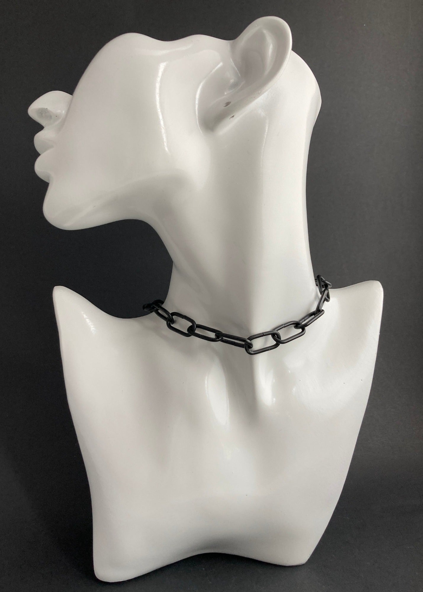 (Shown) Chunky Paper Clip Chain. Black stainless steel. Our Paper Clip Chains now come in three Classic finishes - Black, Silver Plated, and Gold Plated-each offering a unique shape: Black is rounded while the Plated variants are square. Lengths of 16" (Choker), 18", and 22". All are available in both choker and necklace styles, with an especially-sized hoop for added ease when connecting the clasp. With an occasional wipe, your chain will stay sparkling and bright.